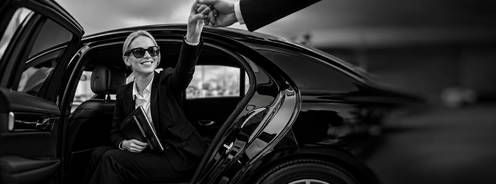 Passenger smiling in the back seat, holding the chauffeur's hand