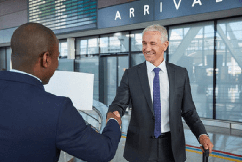 Chauffeur greeting a business passenger at the airport arrivals terminal