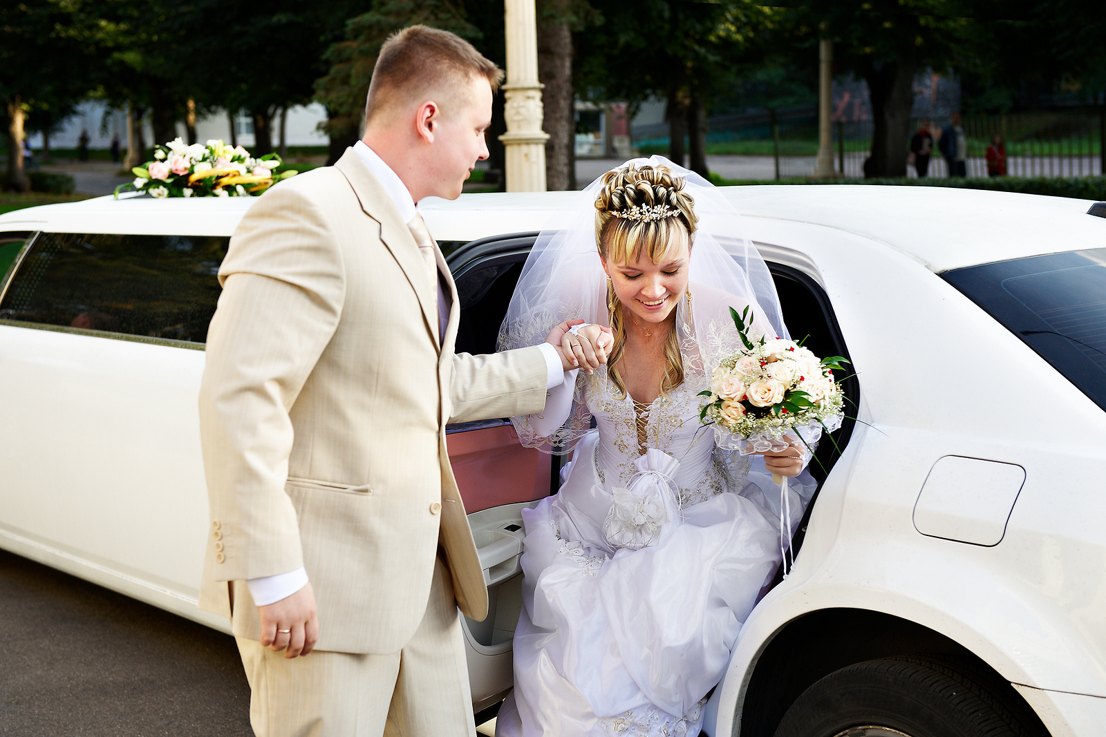 Bride stepping out of a white limousine in Encino