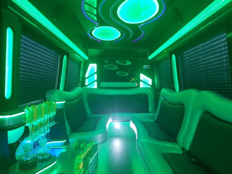 Mercedes Sprinter party interior with green lighting and lounge seating